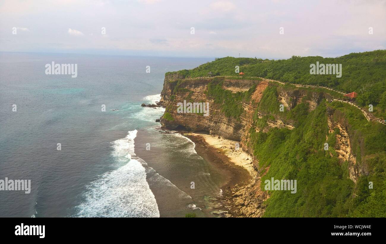 Scenic View Of Cliff By Sea At Bali Island Stock Photo