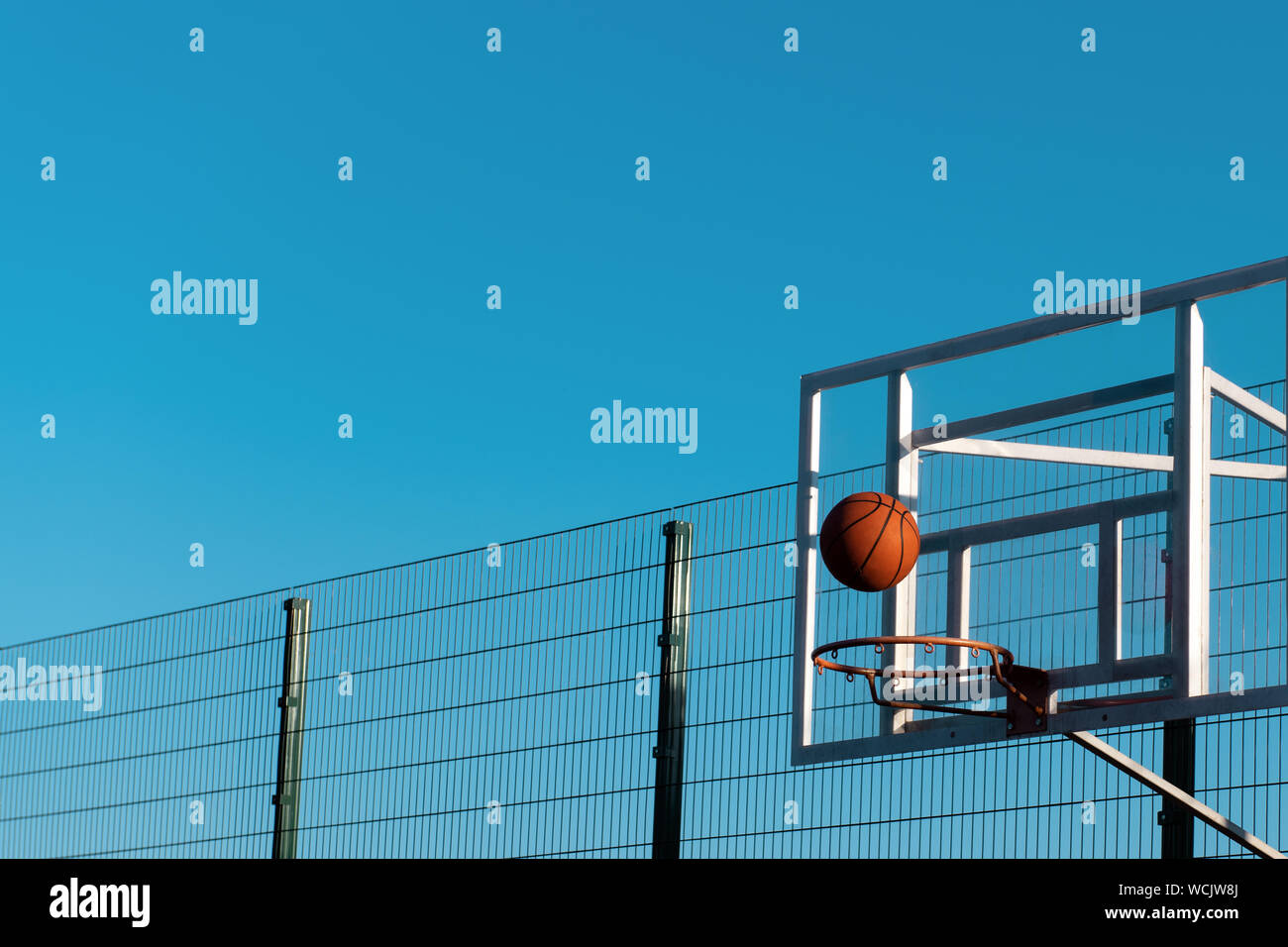 Basketball ball is hitting the target. Ball is flying to the basketball