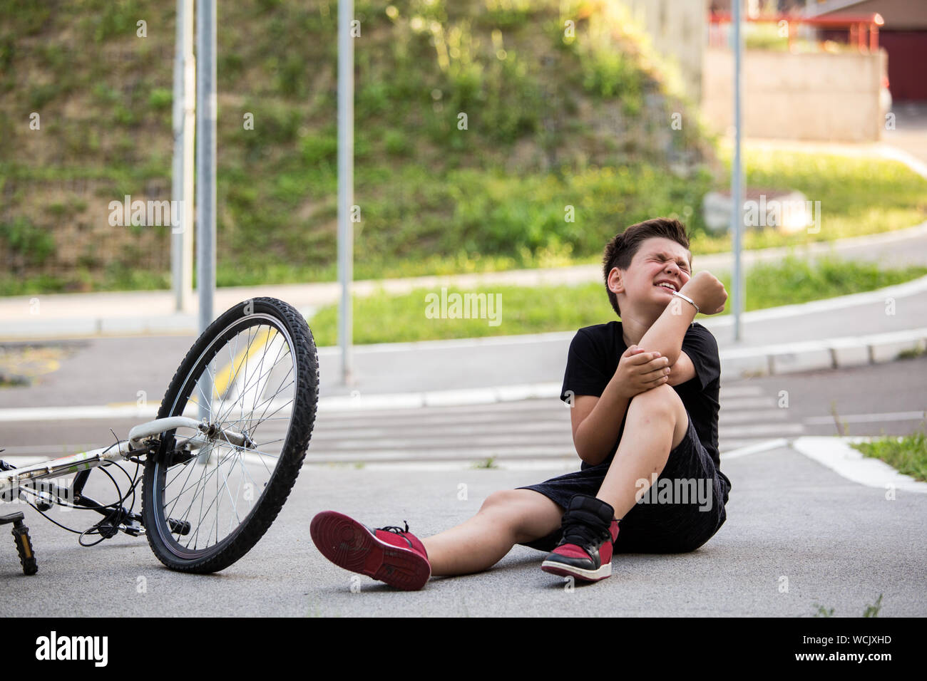 Boy injury hurts from falling bike, hurt on his arms, pain ache from