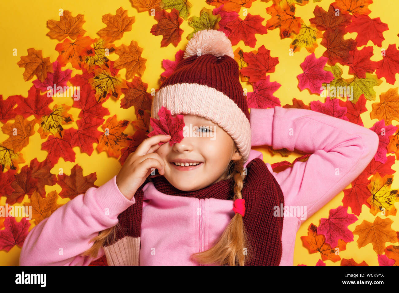 Top view of a happy child lying on the autumn leaves Stock Photo - Alamy