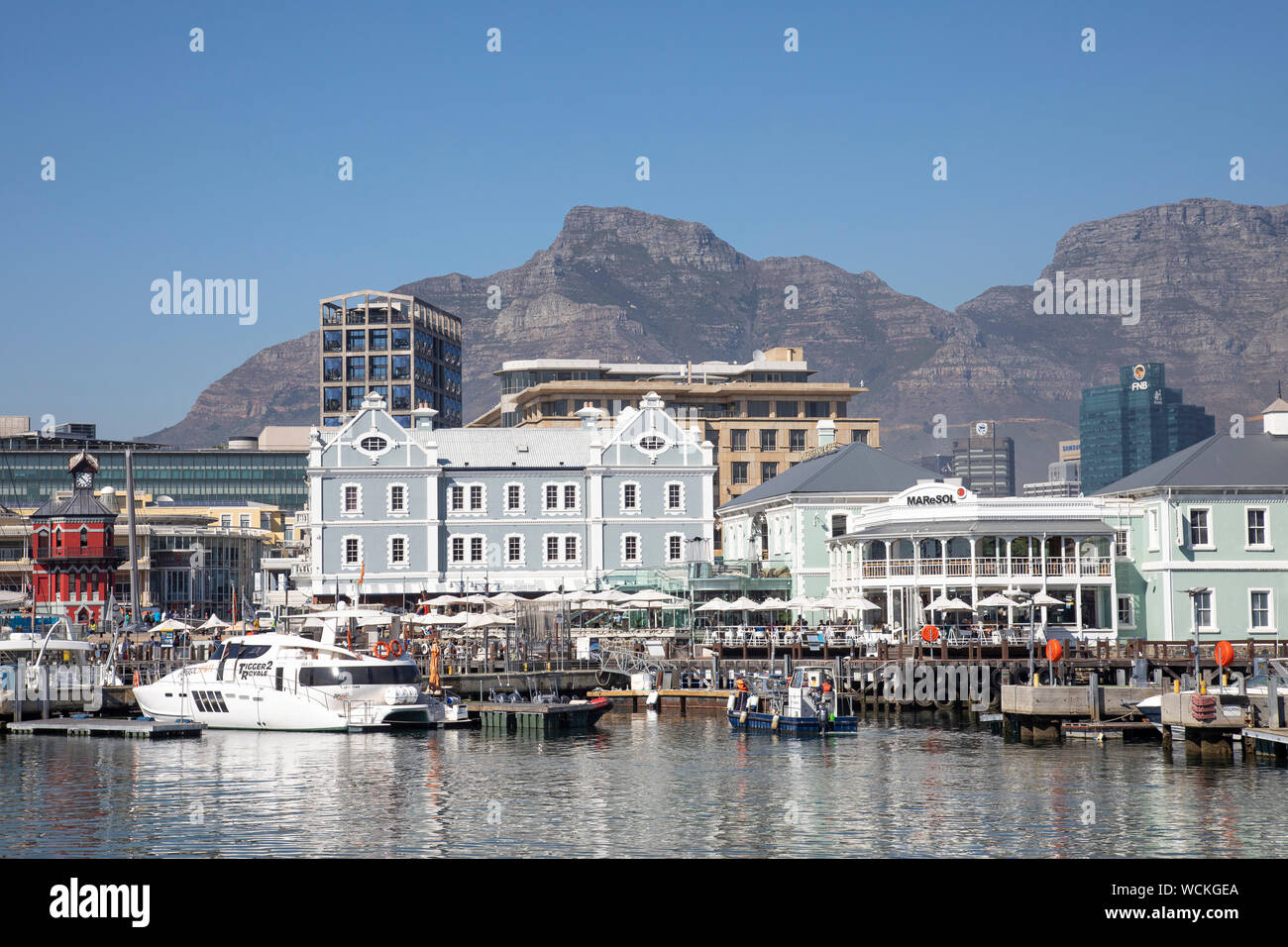 View of the harbour and African Trading Post with Devils Peak and Table Mountain behind, V and A Waterfront, Cape Town, Western Cape, South Africa Stock Photo