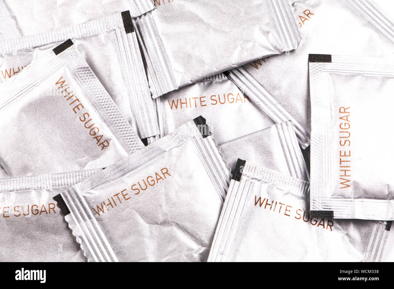 Close Up Of White Sugar Packages Stock Photo