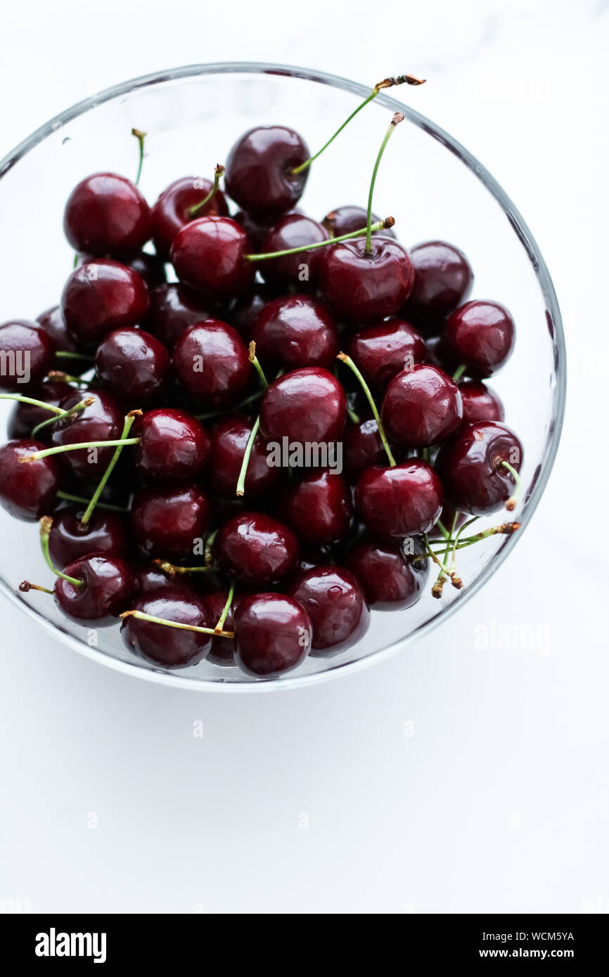Organic food, vegan dieting and health concept - Fresh sweet cherries, juicy cherry berries fruit dessert as healthy diet background Stock Photo