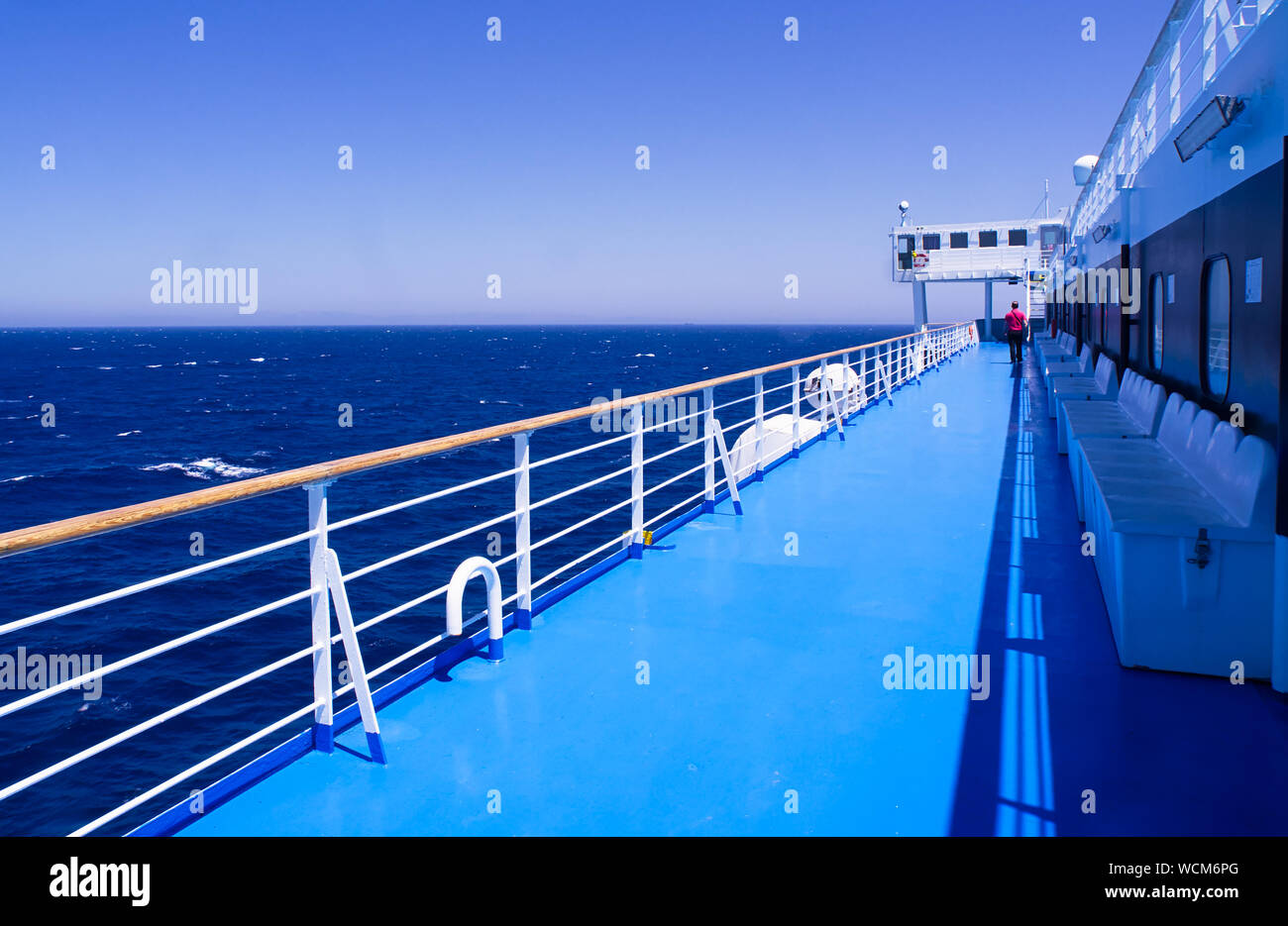 Man walking alone on ship ferry deck , during sail in Aegean sea, Greece. Stock Photo