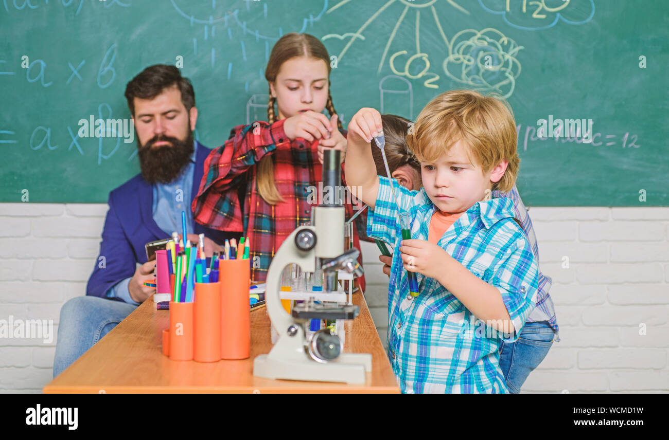 School chemistry laboratory. back to school. Educational concept. Pupils in the chemistry class. happy children teacher. children scientists making experiments in laboratory. Stock Photo