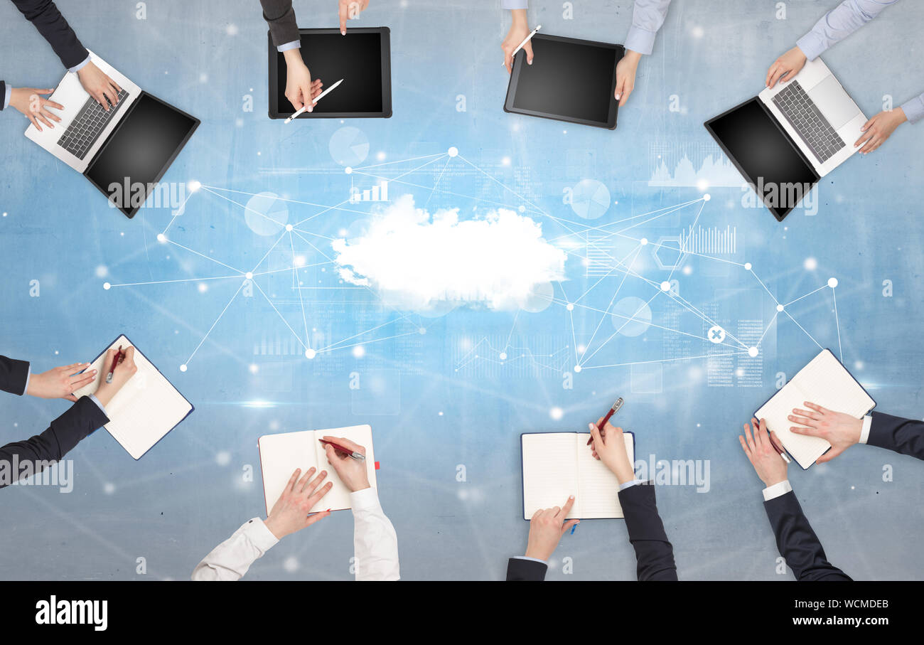Group of people with devices in hands working on reports with online ...