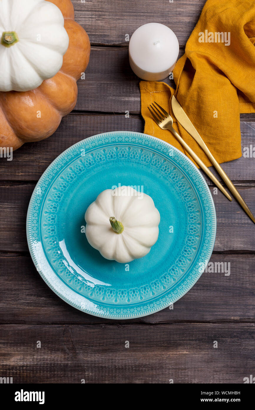 Empty serving plate with pumpkin, tableware and napkin on wood background.  Concept of harvesting table set. Serving plate for Thanksgiving and Hallowe  Stock Photo - Alamy