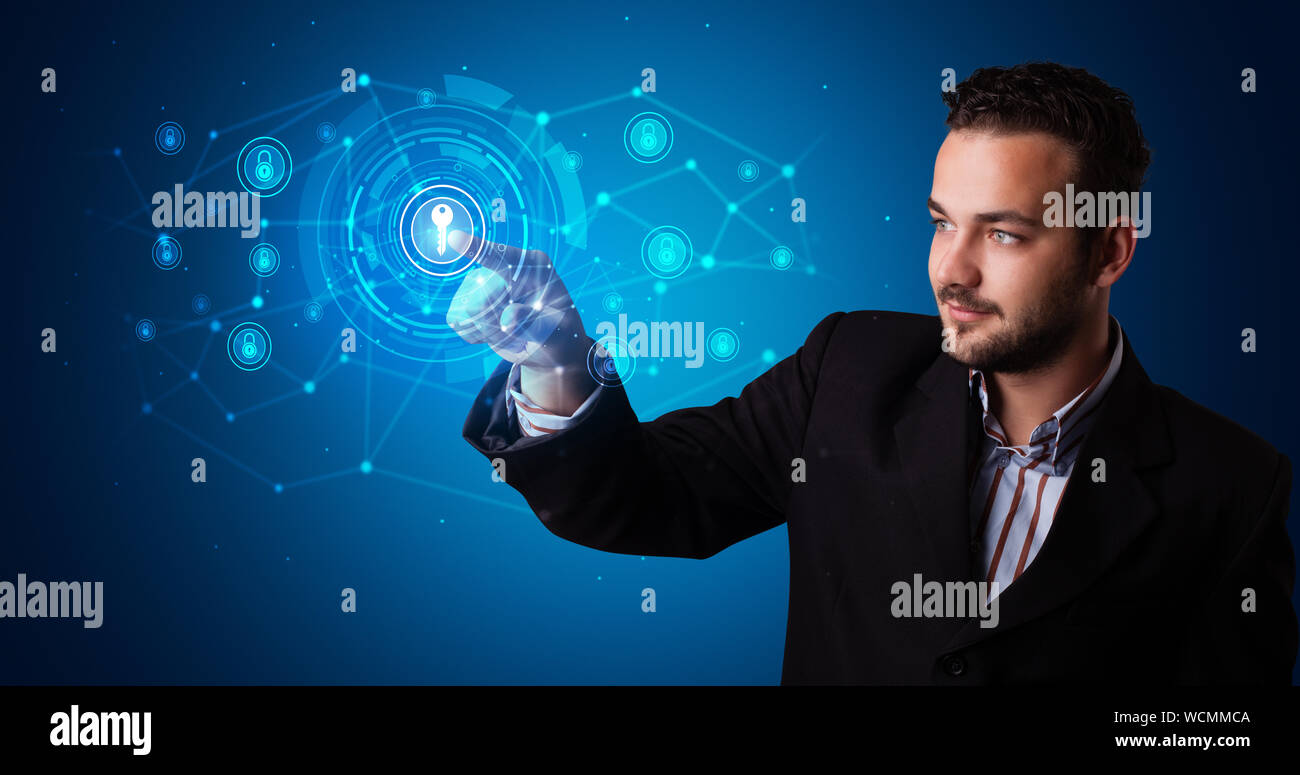 Man touching hologram screen displaying keys and locks Stock Photo