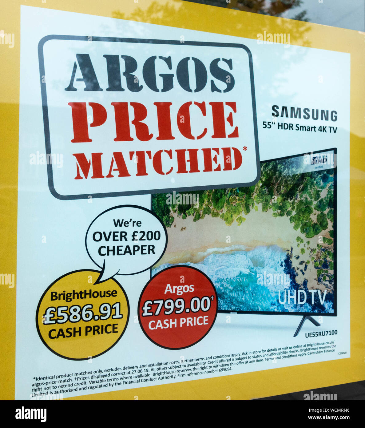 Sign in BrightHouse store window offering price match with Argos. UK