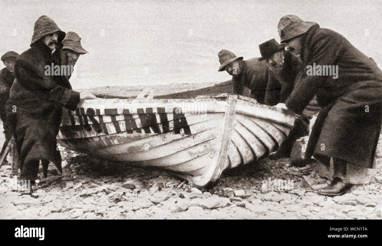One of the lifeboats from the RMS Lusitania, sunk by a German U-boat in 1915, is hauled onto the beach on the coast of Ireland.  From The Pageant of the Century, published 1934. Stock Photo