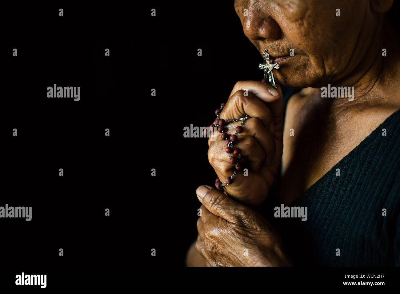 Woman praying with rosary hi-res stock photography and images - Alamy