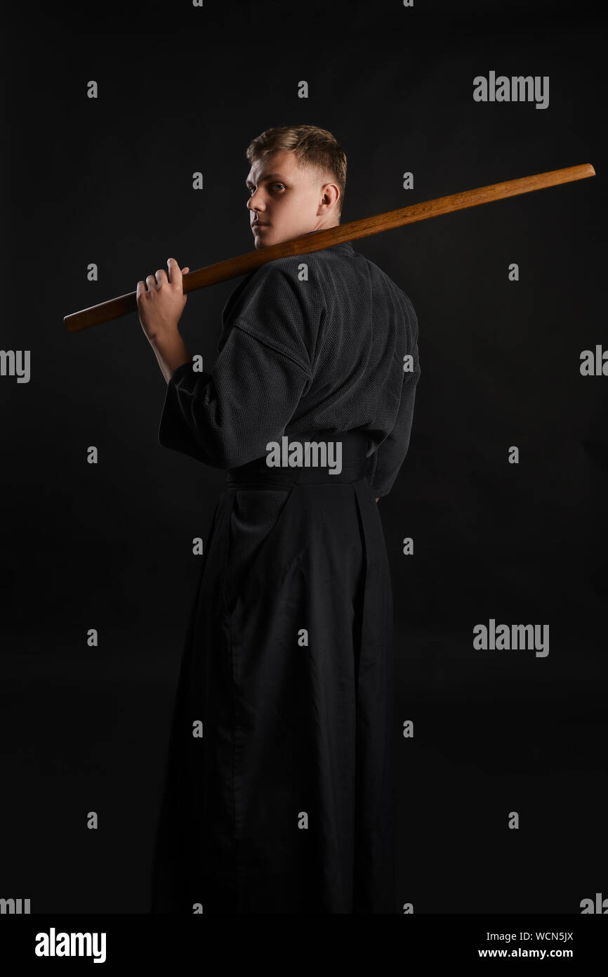 Experienced Kendo warrior wearing in a traditional japanese kimono is  standing back to the camera while practicing martial art with the shinai  bamboo Stock Photo - Alamy