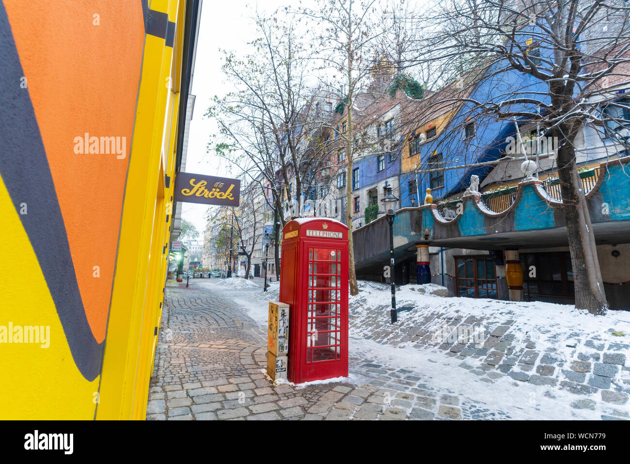 British red phone box in the colorful Hundertwasser Village, Hundertwasserhaus, Vienna, Austria Stock Photo