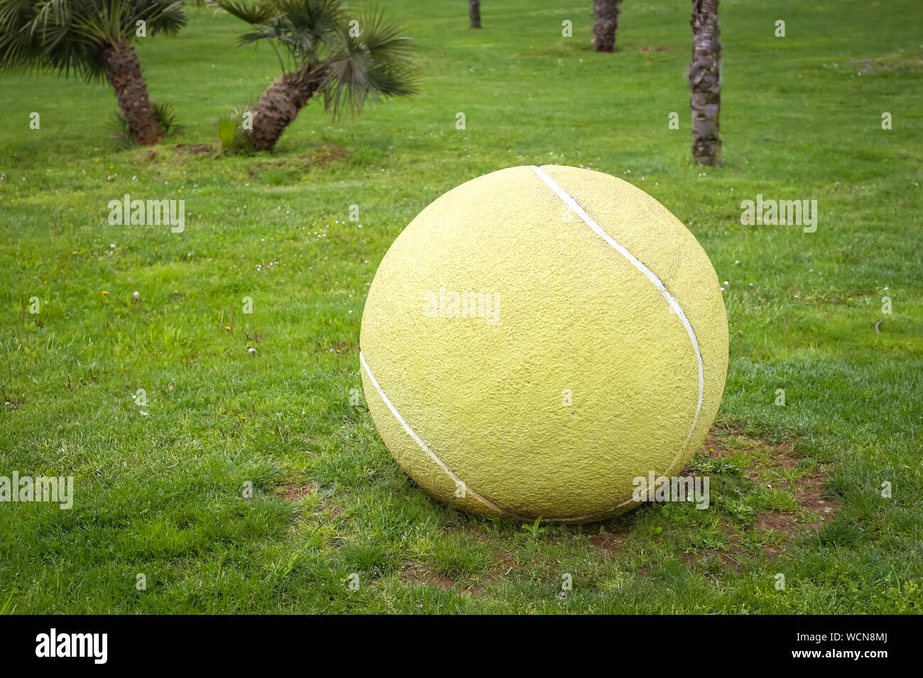 Umag, Croatia 14th April, 2019 Tennis ball sculpture on the meadow