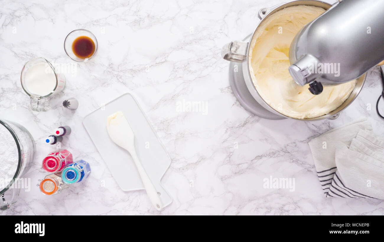Mixing ingredients in standing kitchen mixer to make buttercream