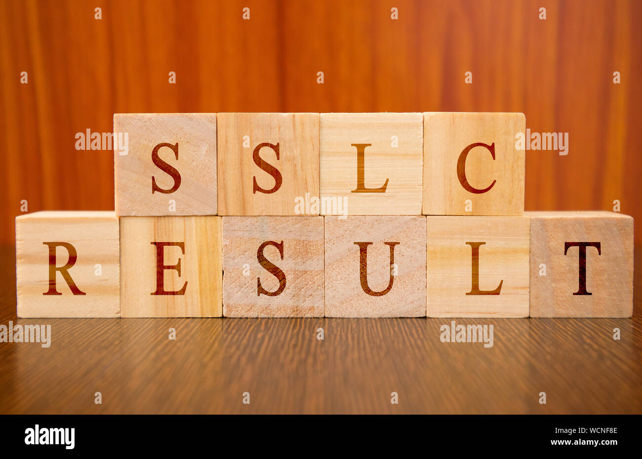 Concept of SSLC exam Results conducted in India, in wooden block letters on table Stock Photo