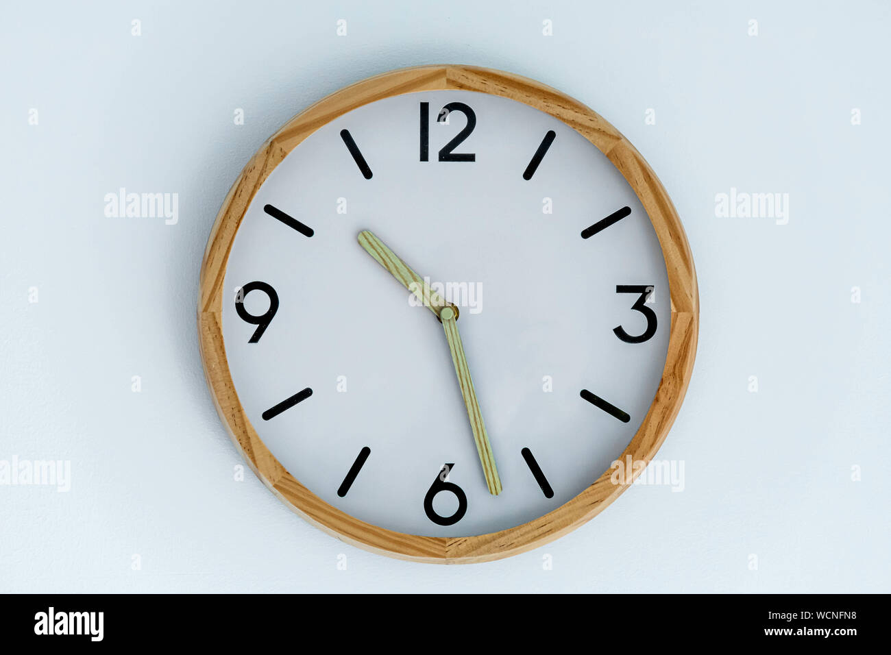 trditional clock on white wall background isolated Stock Photo Alamy