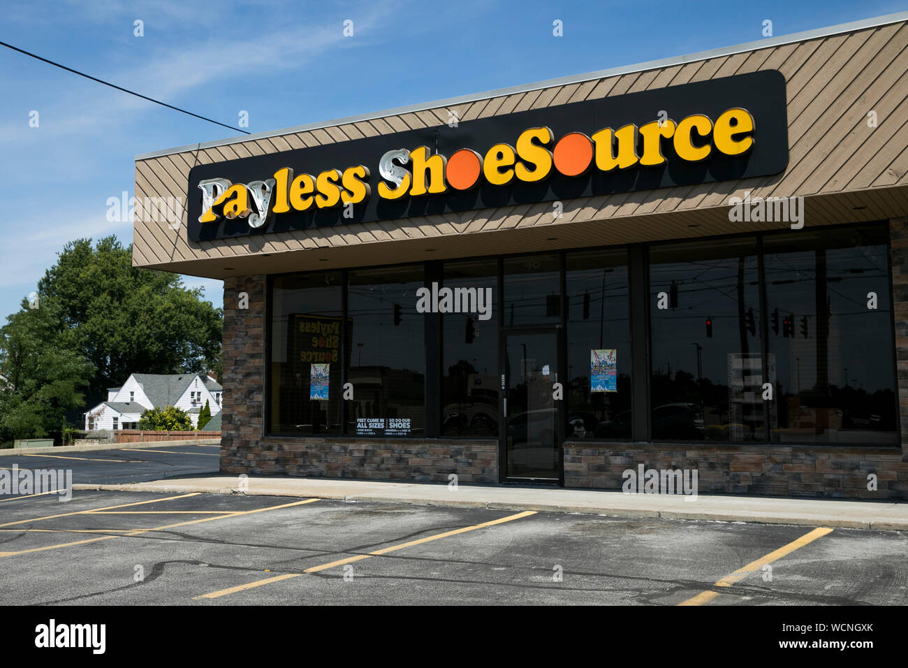 A logo sign outside of a closed Payless ShoeSource retail store ...
