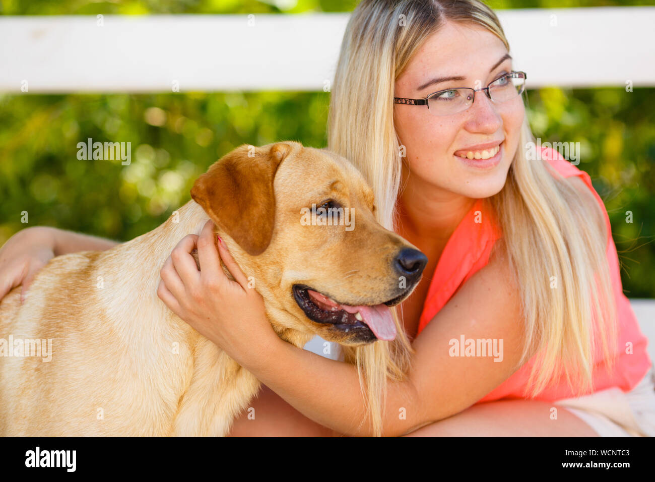 portrait of Beautiful young girl with her dog labrador retriever ...