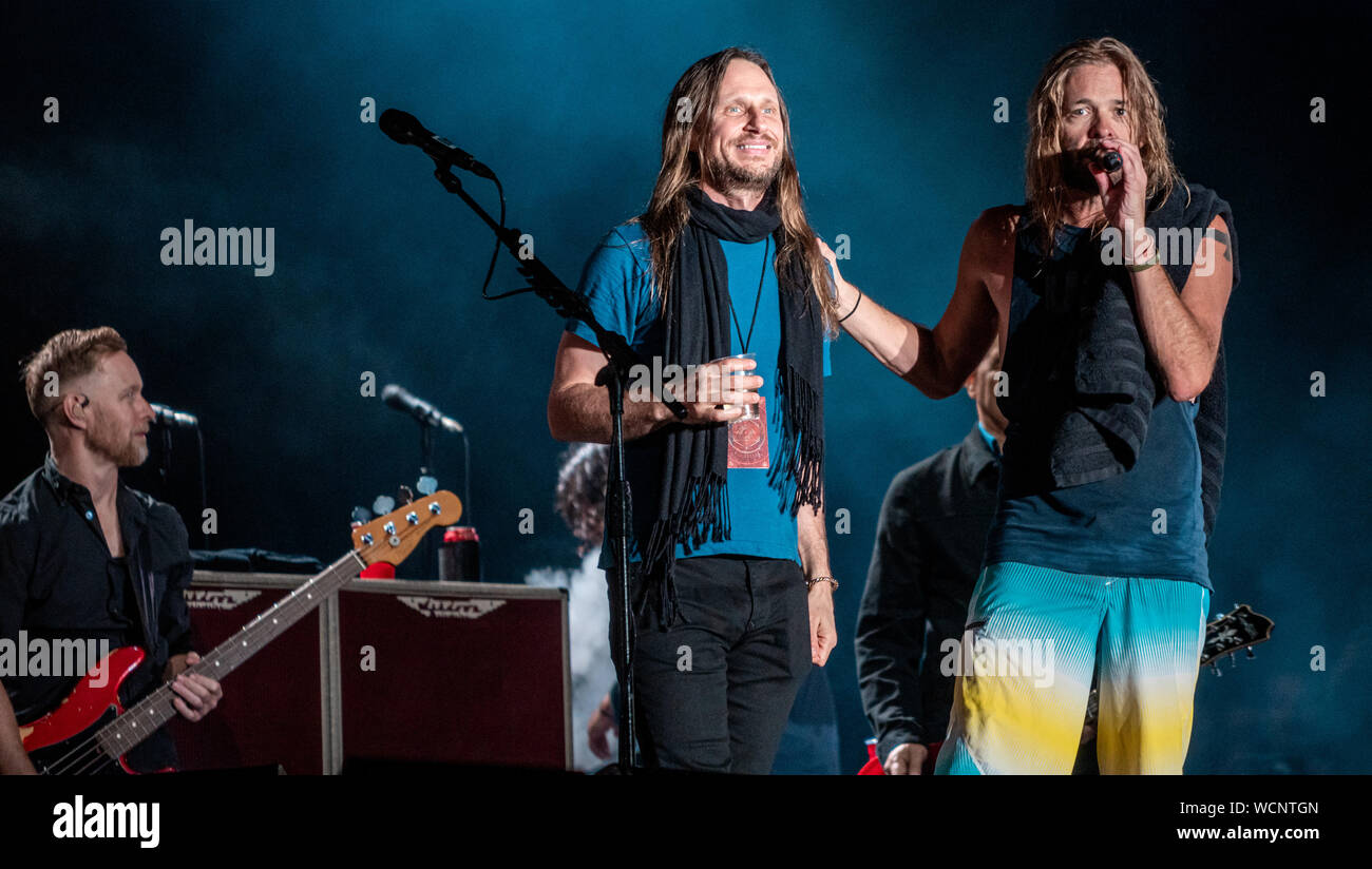 Taylor Hawkins duetting with Yes Vocalist Jon Davison during Foo Fighters performing at RDS Arena, Dublin 21st August 2019 Stock Photo