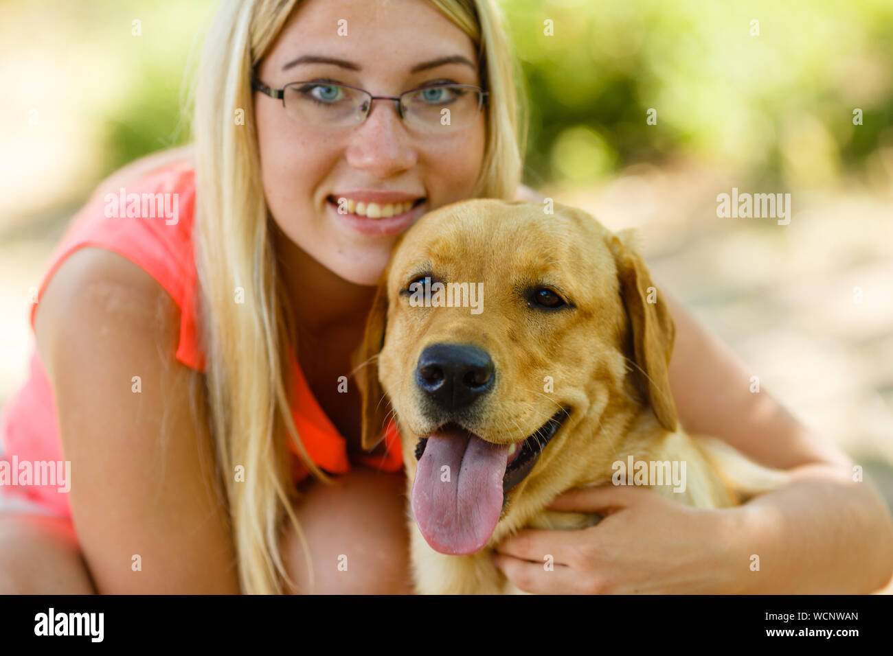 portrait of Beautiful young girl with her dog labrador retriever ...