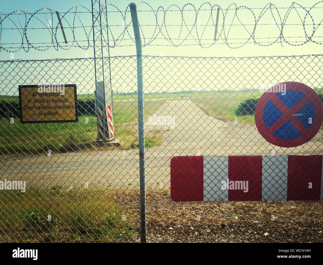 No Stopping Sign By Chainlink Fence Stock Photo