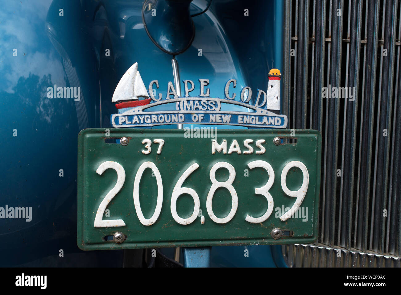 A 1937 license plate and Cape Cod marker on an antique auto. Stock Photo