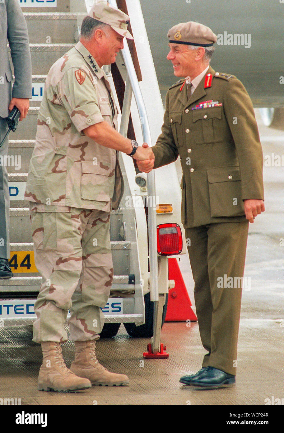 U.S. General Norman Schwarzkopf is greeted by British General  Sir Peter de la Billière at London's Heathrow Airport in July 1991. Stock Photo