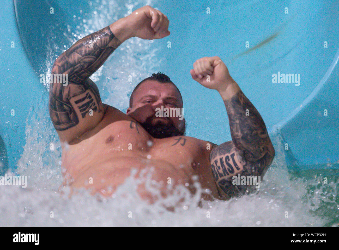 Former World's Strongest Man Eddie Hall while being dropped down the "tallest and fastest" water slide in the UK, The Thunderbolt, at Waterworld in Stoke-On-Trent in Staffordshire. Stock Photo
