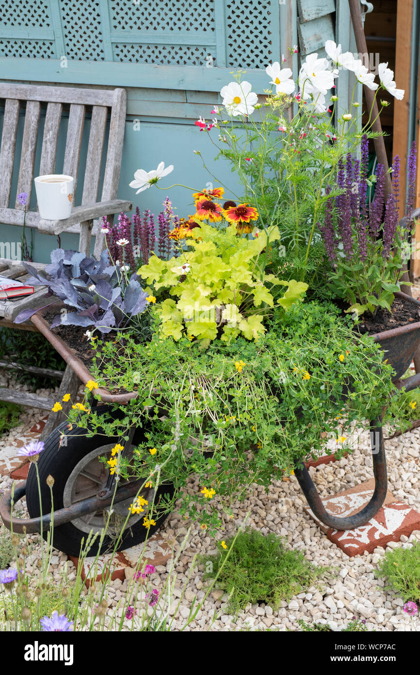 Old wheelbarrow floral display at RHS Hampton court flower show 2019. Hampton Court, Surrey, England Stock Photo