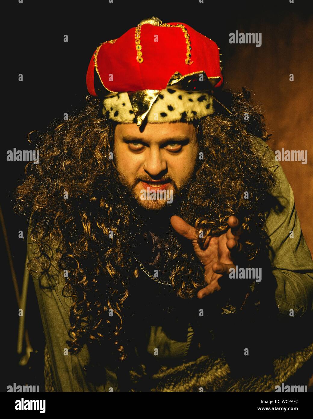 Close-up Of Man Wearing King Costume While Acting On Stage Stock Photo