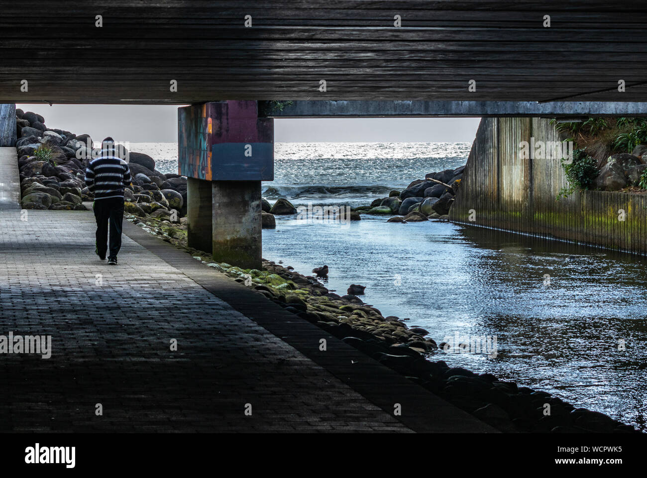 Man walking through underpass in New Plymouth, New Zealand Stock Photo