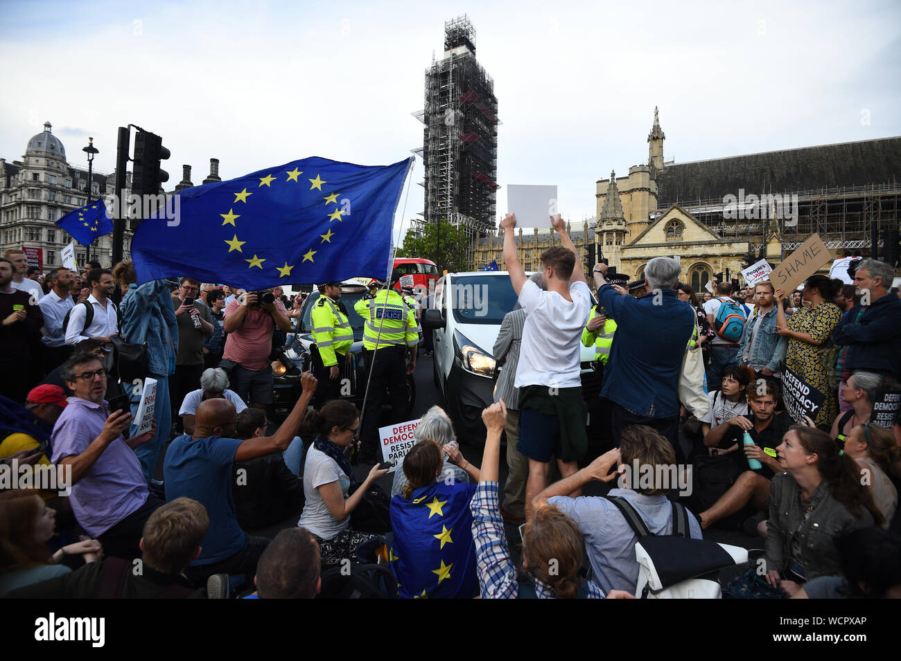 Protesters stop traffice outside the Houses of Parliament, London, as they demonstrate against Prime Minister Boris Johnson temporarily closing down the Commons from the second week of September until October 14 when there will be a Queen's Speech to open a new session of Parliament. Stock Photo