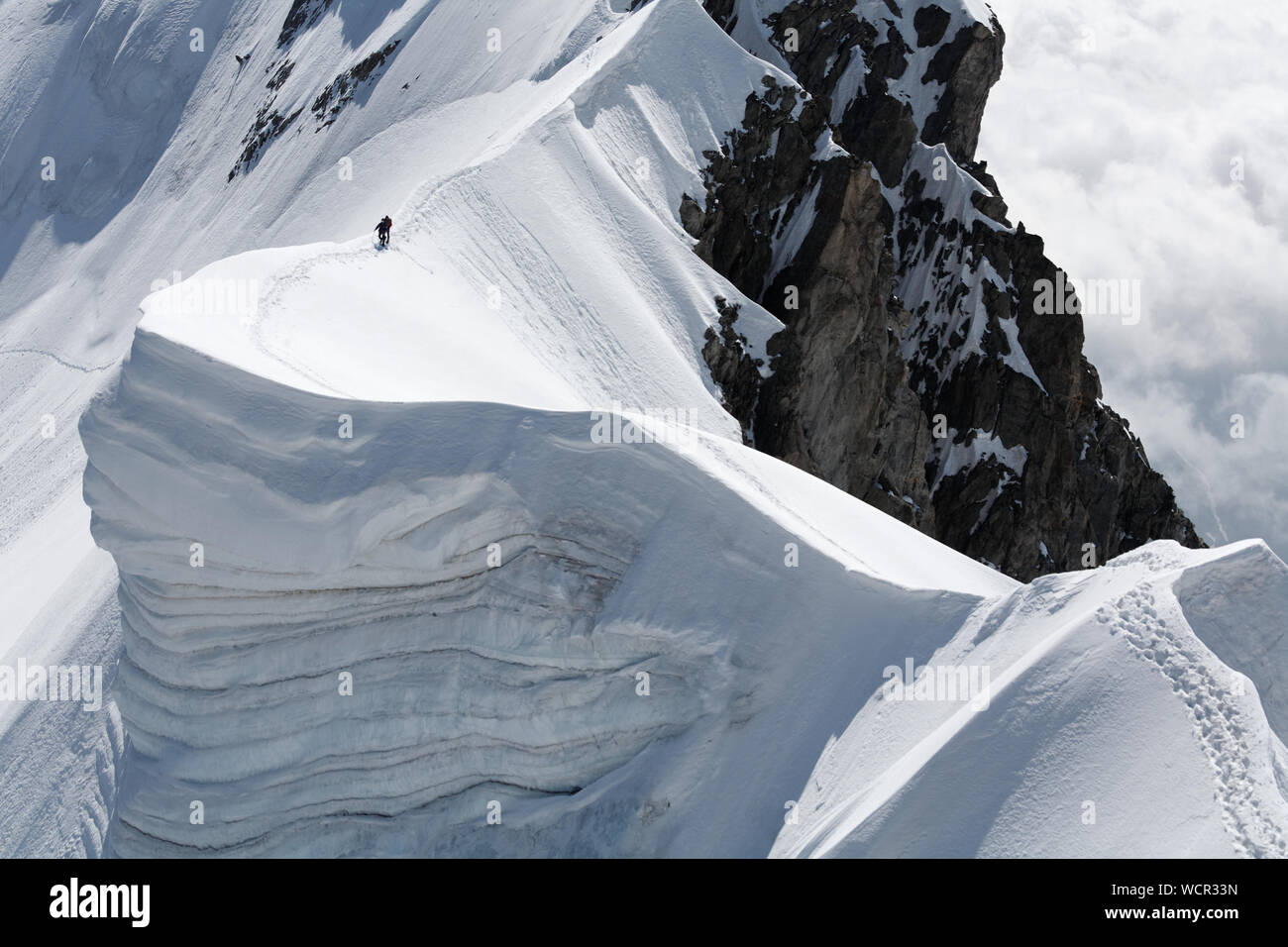 Scenic View Of People On Snow Covered Aiguille De Rochefort Stock Photo