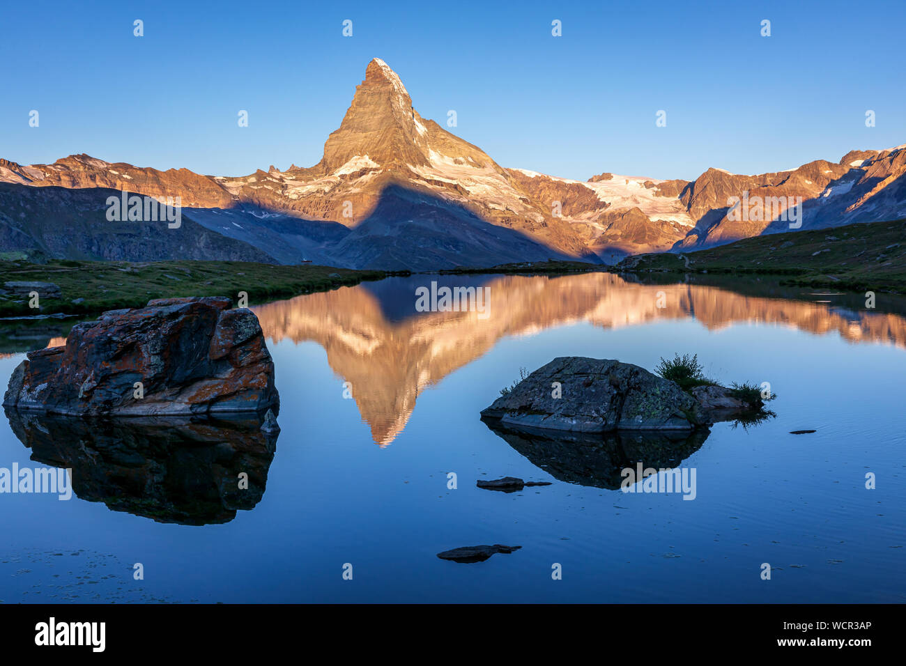 Matterhorn reflected in the Stellisee at sunrise, Zermatt, Valais ...