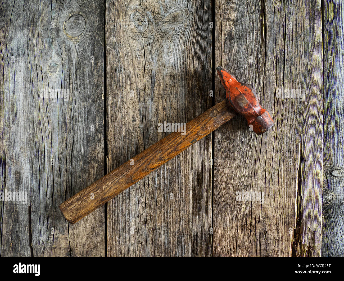 Directly Above View Of Hammer On Wooden Table Stock Photo