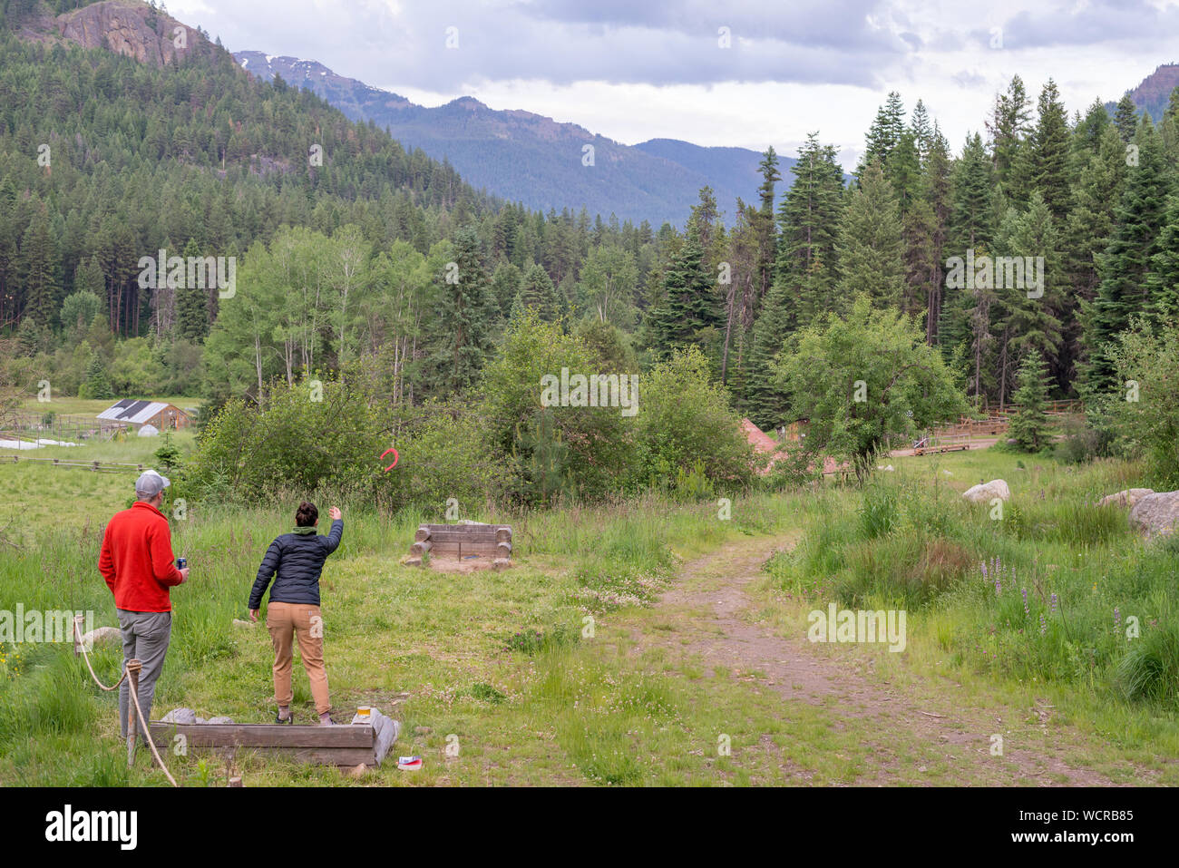 Couple playing horseshoes at the Minam River Lodge in Oregon's Wallowa