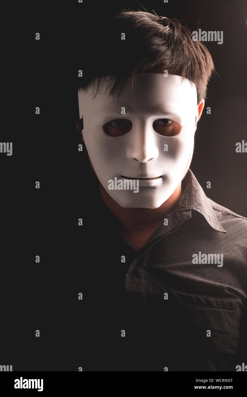 Portrait Of Man In Mask Against Black Background Stock Photo Alamy