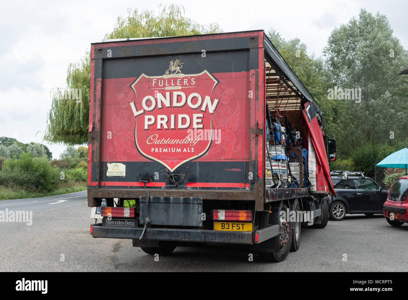 Fullers London Pride beer lorry or truck delivering ale kegs to a pub public house, UK Stock Photo