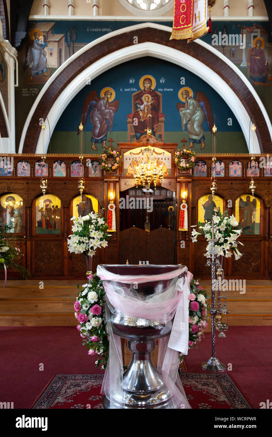 A baptismal font in a Greek Orthodox church, a furniture used for baptism during a christening ceremony. Stock Photo