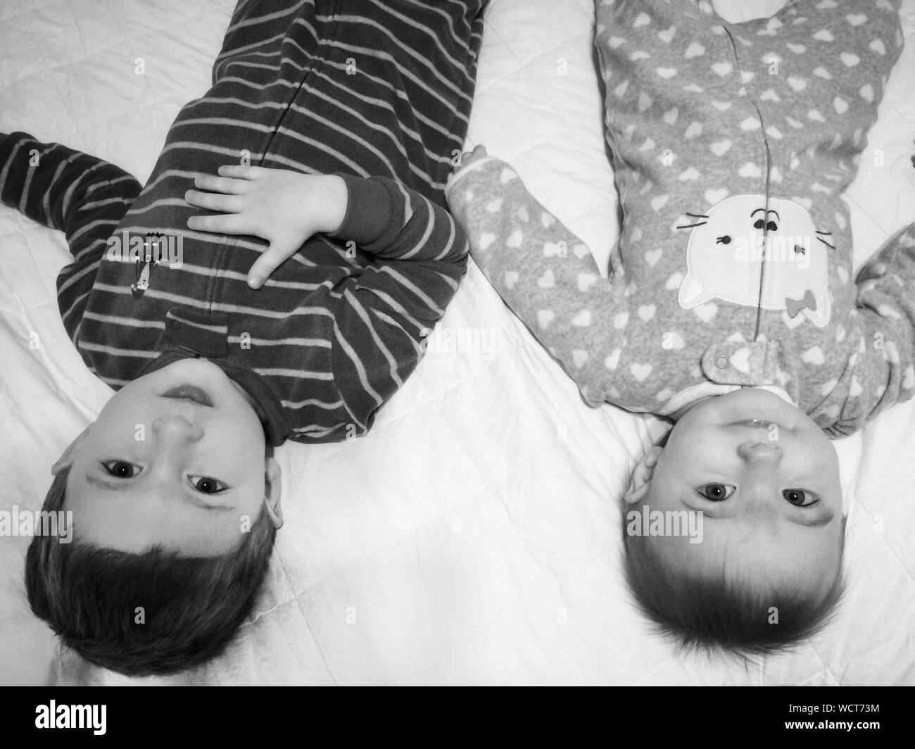 Portrait Of Sibling Lying On Bed Stock Photo Alamy