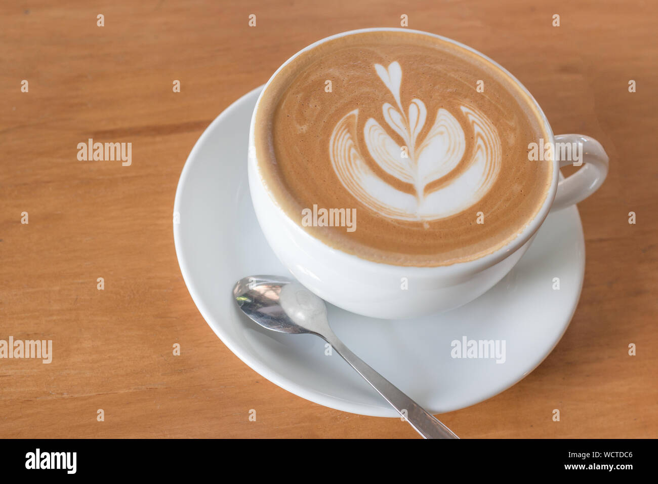 High Angle View Of Cappuccino With Froth Art On Table Stock Photo