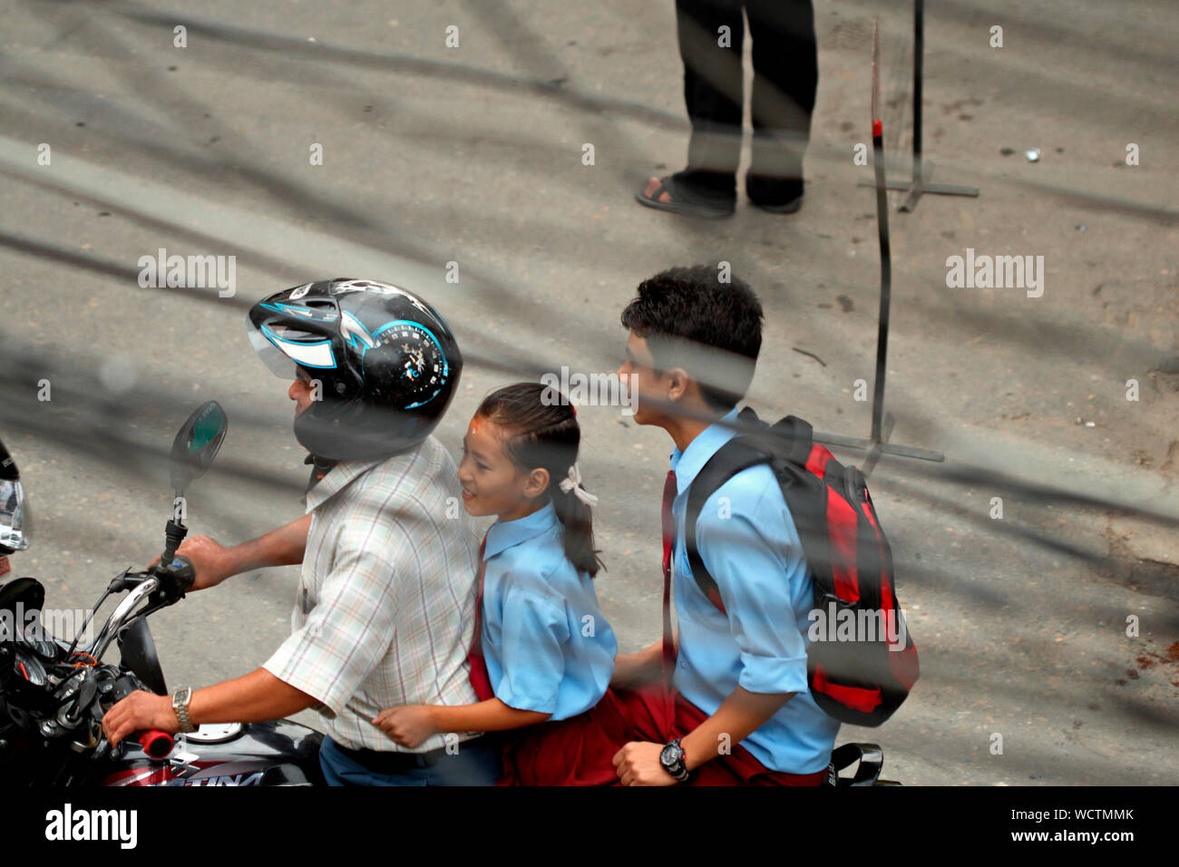 Children riding on a motorbike without any safety gear. Kathmandu, Nepal. 2010. Stock Photo