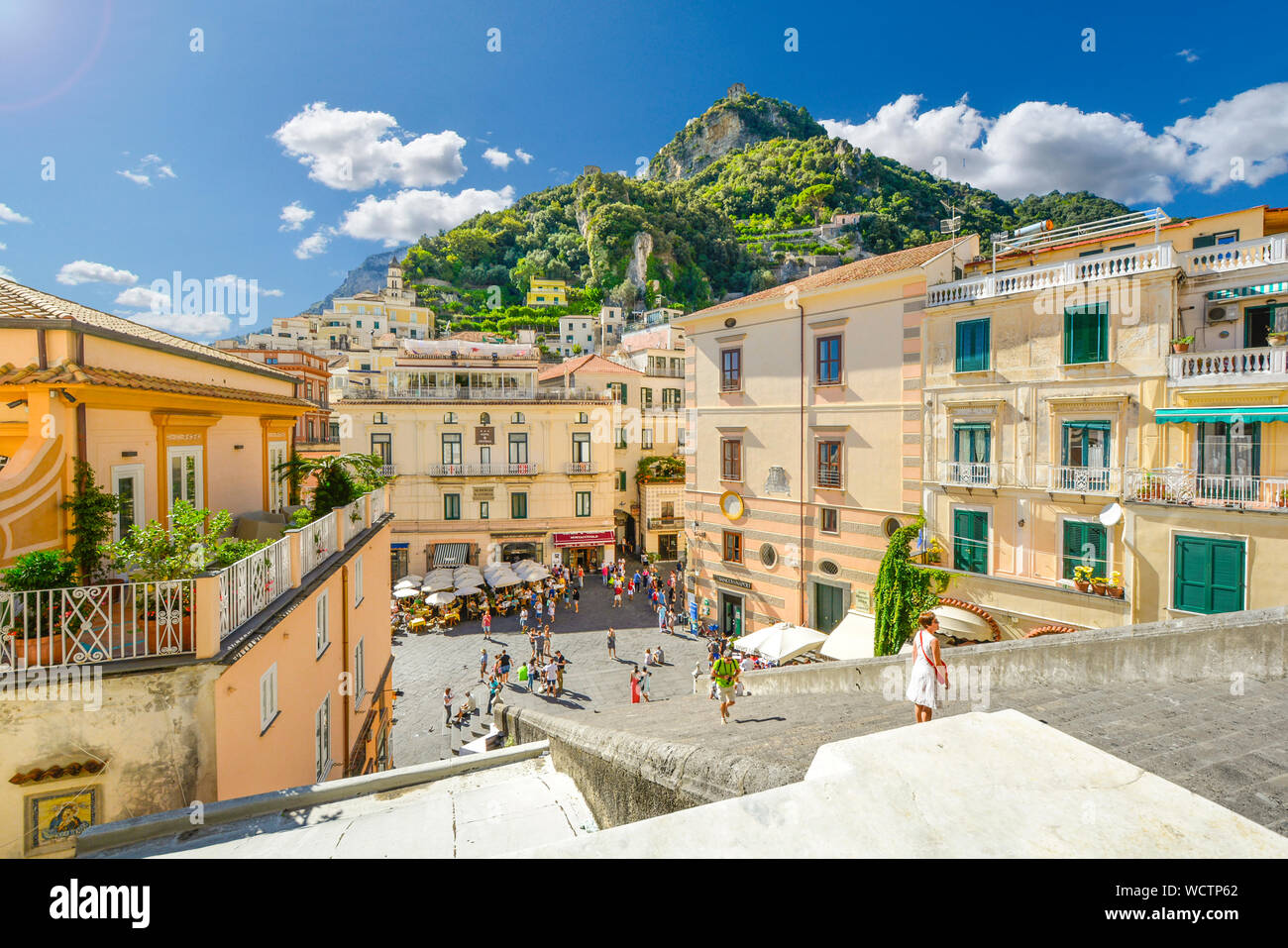 Mountain and city views from the top of the stairs of the Amalfi Cathedral on the Amalfi Coast of Italy with the hilltop Torre dello Ziro fort in view Stock Photo