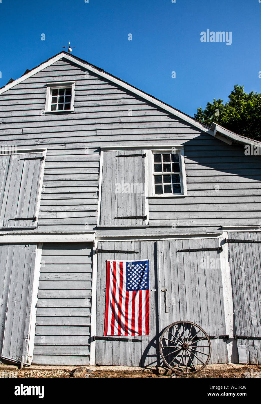 Gray barn with the American flag, Monmouth County, farm in New Jersey