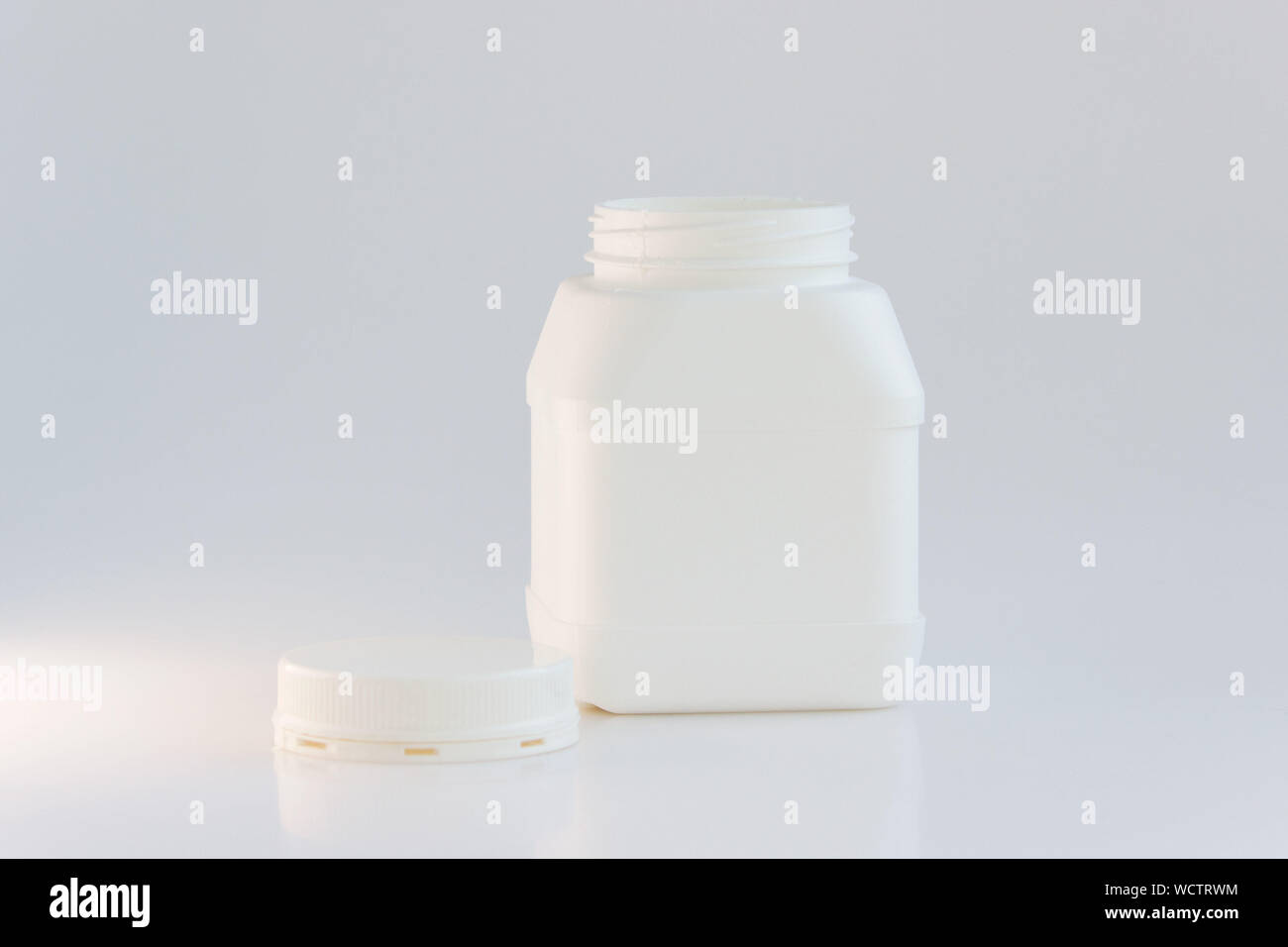 white plastic jar with lid on a white background Stock Photo - Alamy