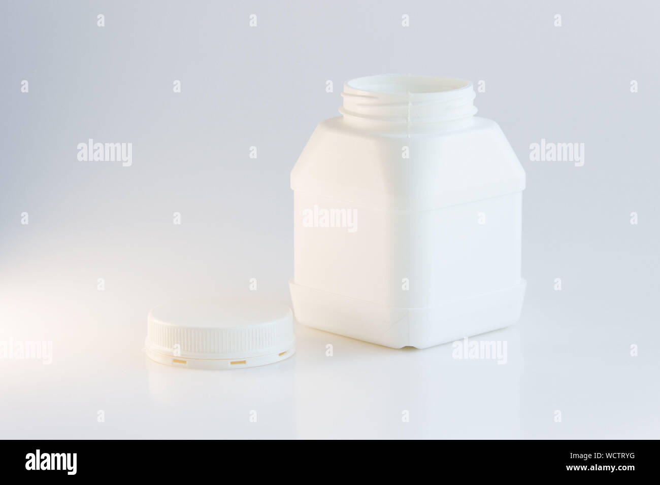 white plastic jar with lid on a white background Stock Photo - Alamy