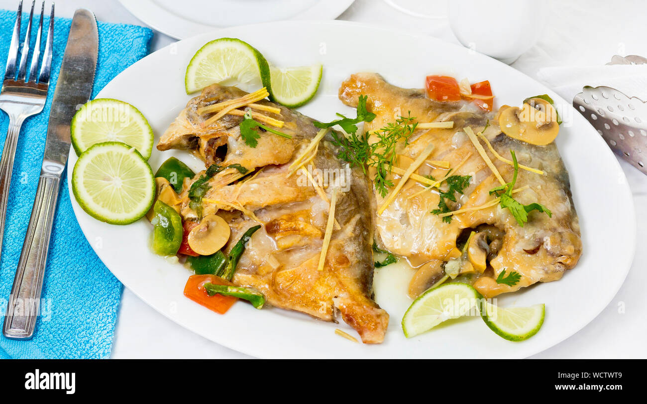 Pomfret fish pieces on plate, spicy Indian dish. Popular amongst Bengalis and south Asia for it's taste. Stock Photo