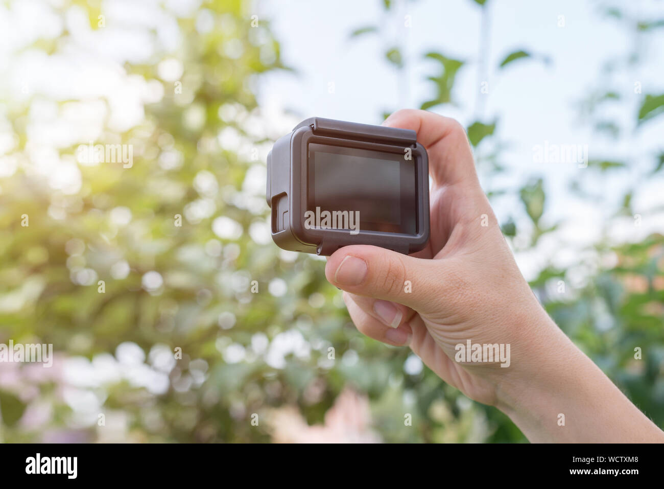 Filmmaking with action camera concept. Blank screen for mockup. Stock Photo