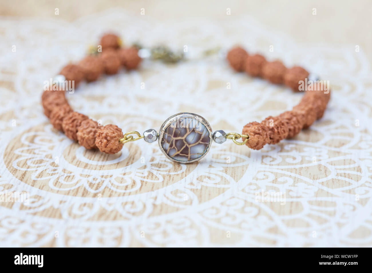 Mother pearl natural bead rudraksha seed bracelet on decorative background Stock Photo